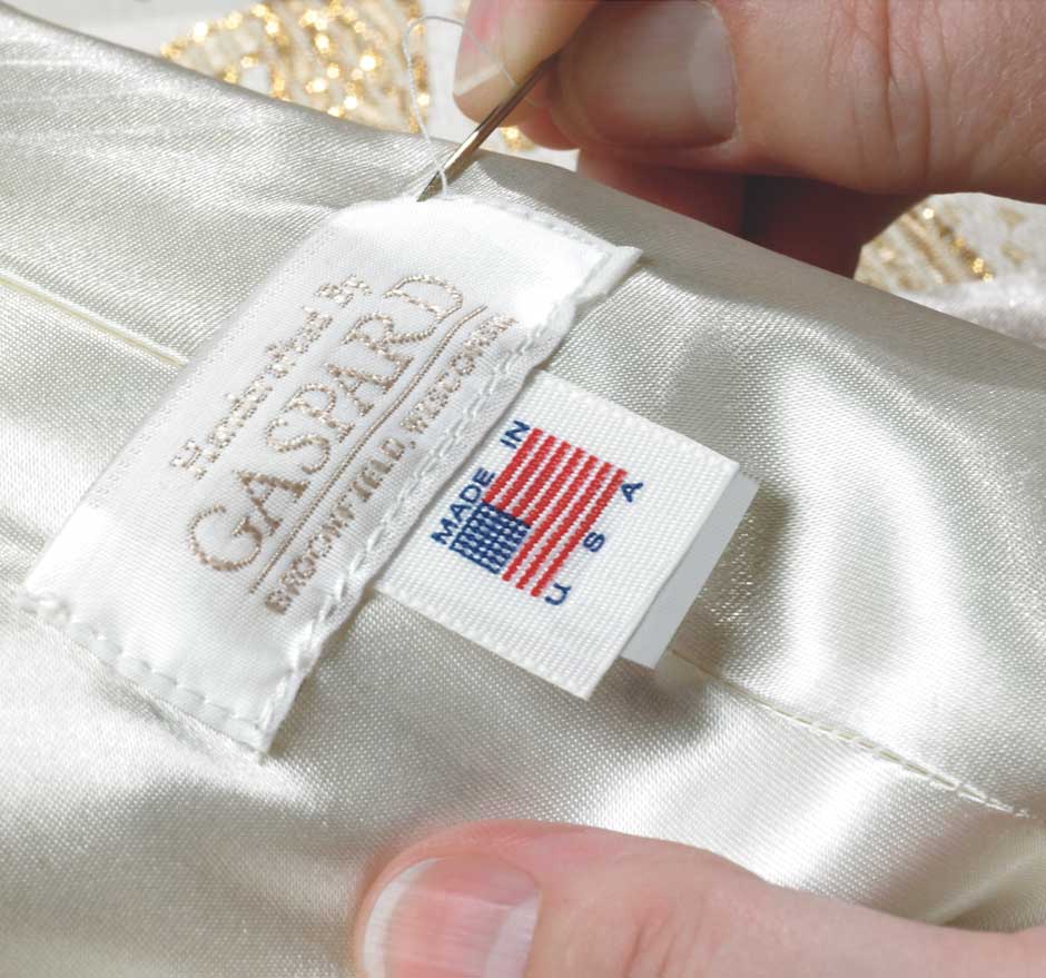Gaspard tag being sewn into a vestment before being shipped to a customer