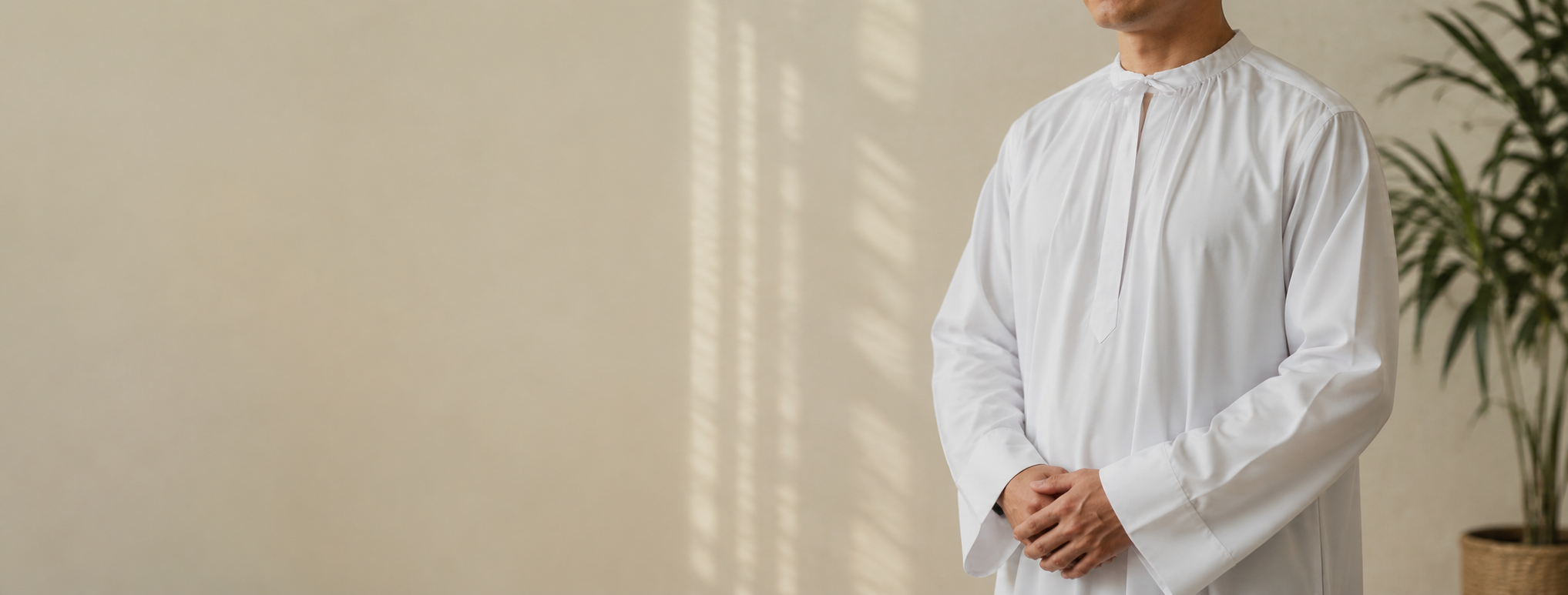 Clergy member wearing lightweight white clergy apparel